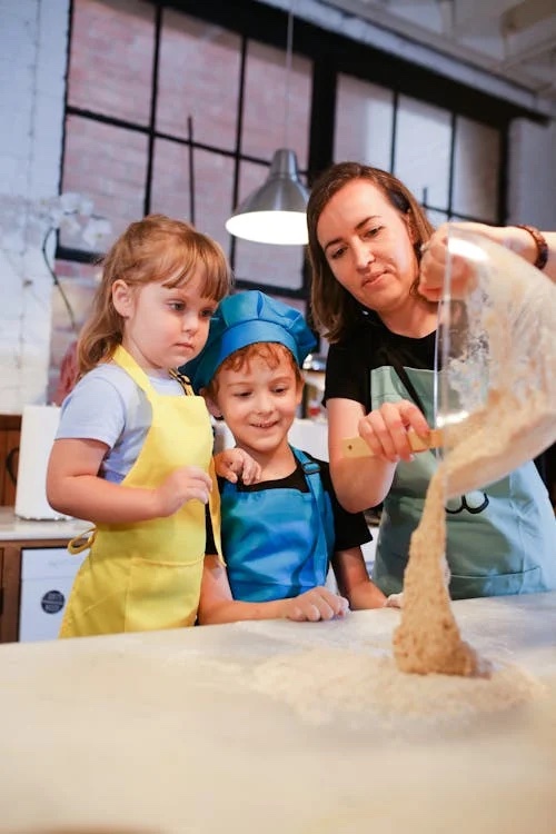 mom and two kids baking Christmas treat