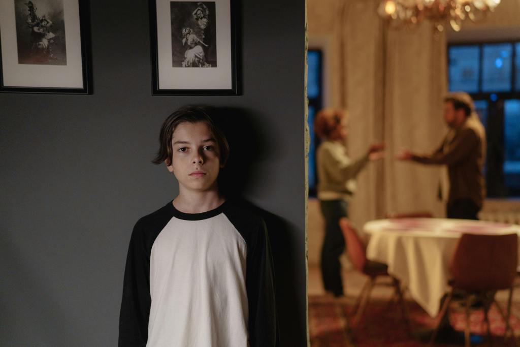 young boy listening to parents fight during a high conflict divorce