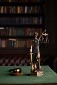 Judges office desk, with a gavel and statue of Lady Justice